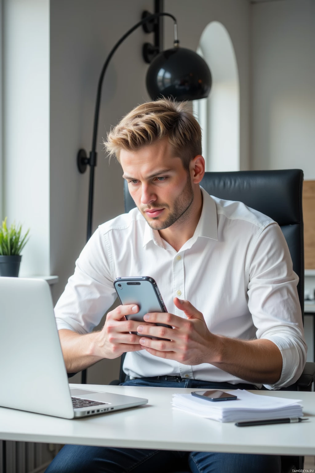 Realistic high quality photo. Male, 29, neat blonde hair, calm serious expression, sharp eyes, wearing a crisp white shirt and dark trousers, sits at a modern office desk in the afternoon, intently scrolling a phone widget displaying a snack‑tracker spreadsheet while a laptop and a tidy desk with minimalistic office décor lie beside him, focused and efficient.